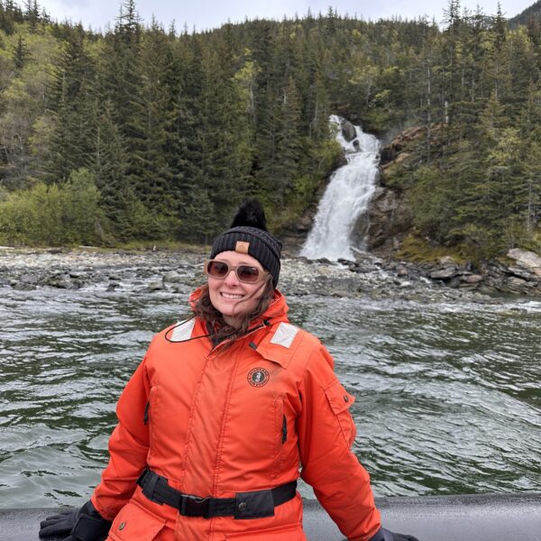 Woman on Ocean raft infront of waterfall