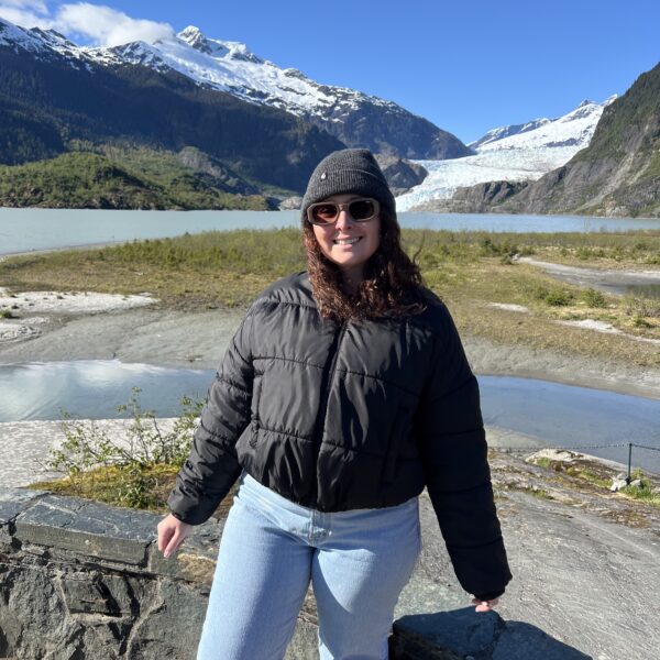 Woman standing infront of the Mendenhall glacier