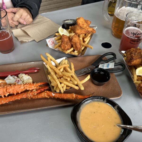 Crab legs, fried fish, and beer on a table